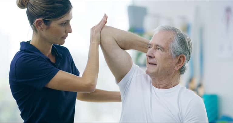 Physiotherapy, woman and elderly man with shoulder pain for stretching, help or care in office. Chi.